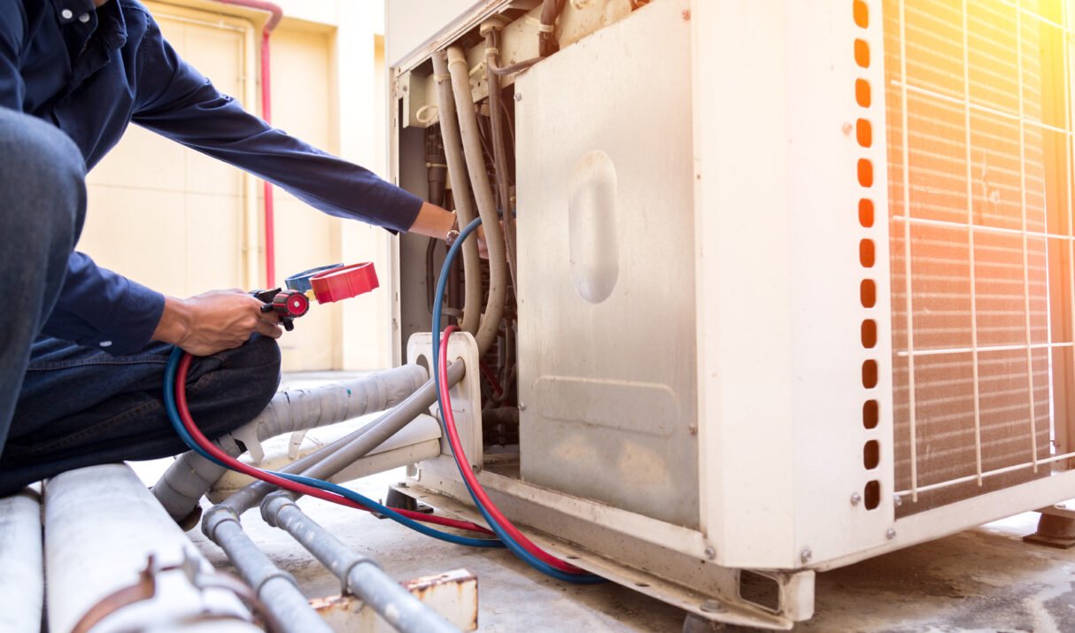 Technician is checking air conditioner ,measuring equipment for filling air conditioners.
